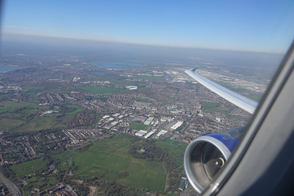 an airplane wing and a city