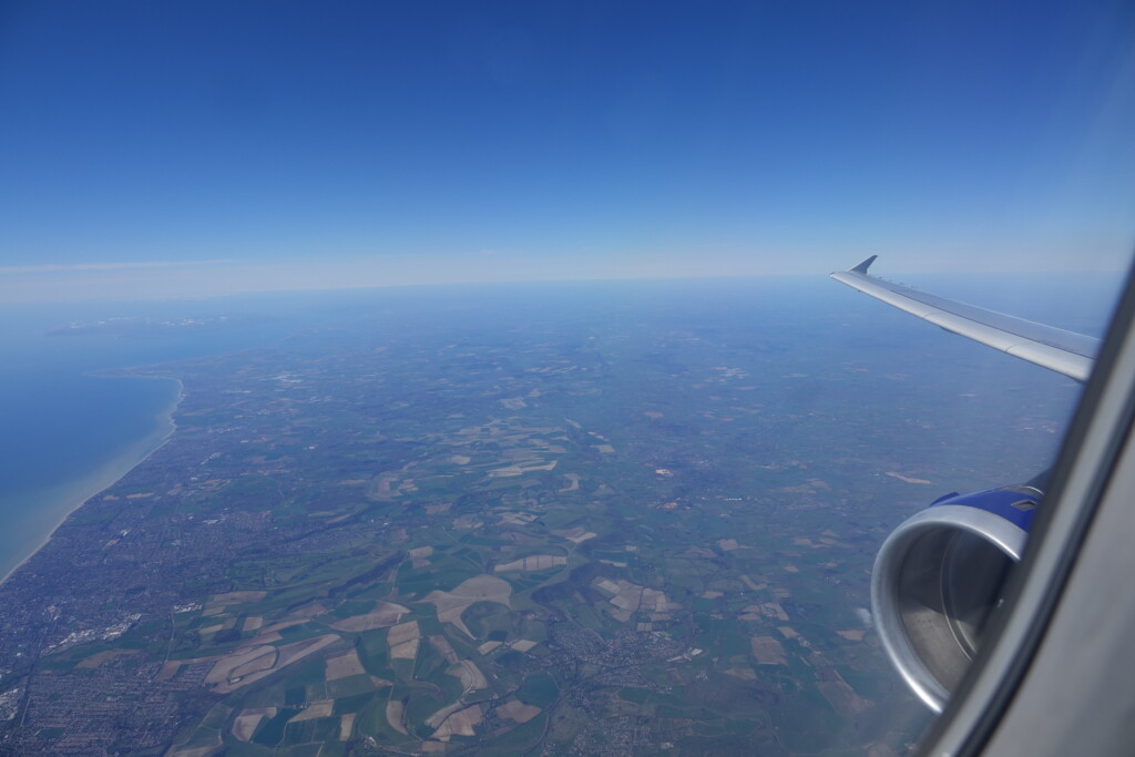 an airplane wing and a landscape