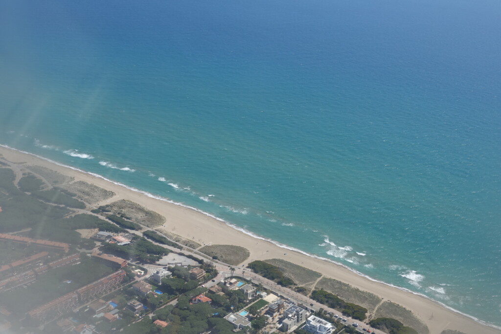 a beach with buildings and water