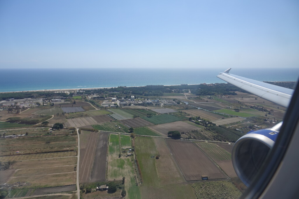 an airplane wing over a landscape