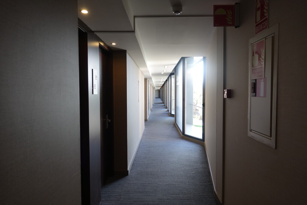 a hallway with doors and a sign