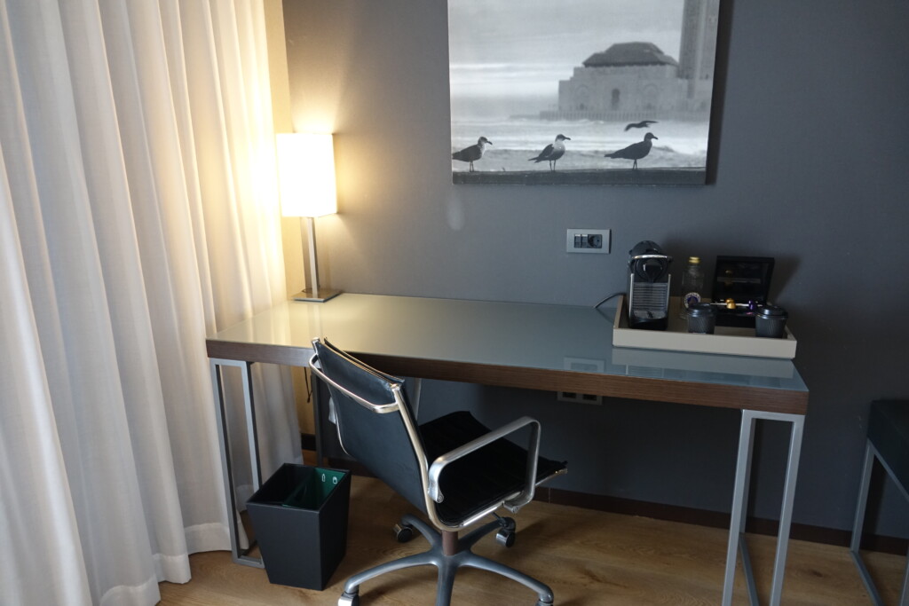 a desk with a chair and a lamp