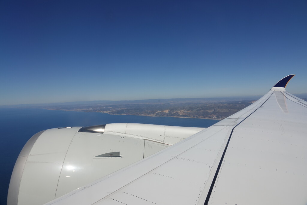 an airplane wing and body of water