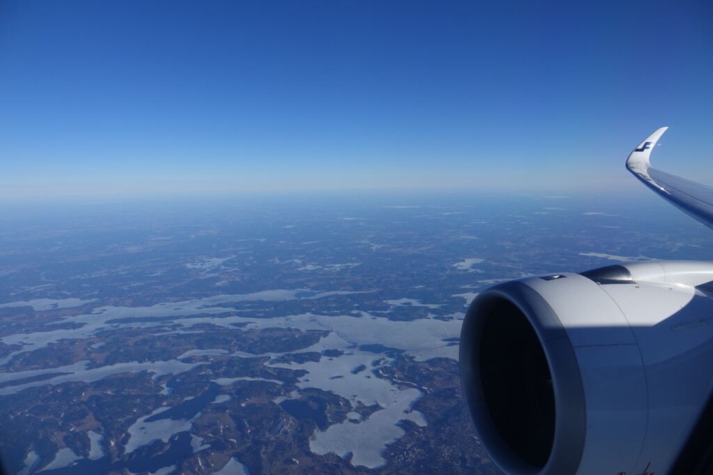 an airplane wing and a blue sky