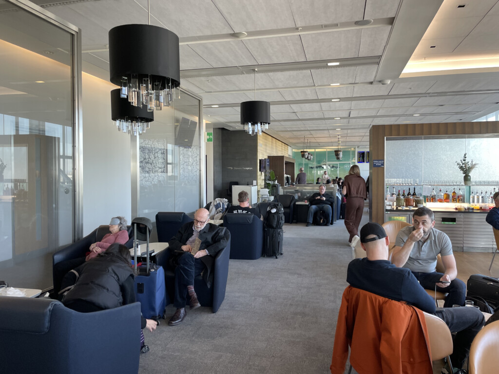 a group of people sitting in chairs in a lounge area