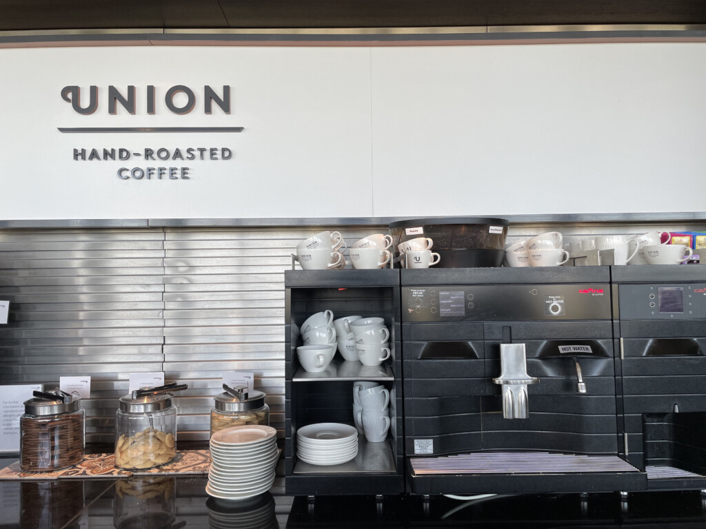 a coffee machine with white cups and plates