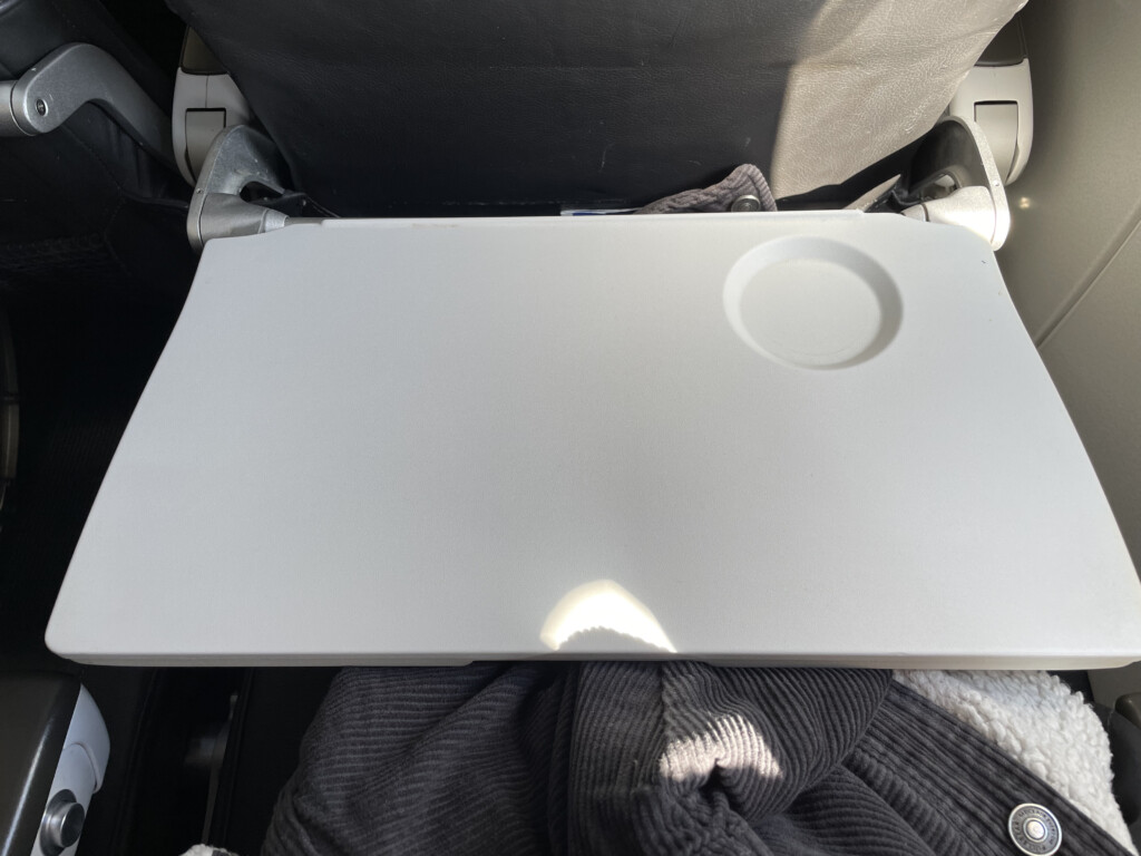 a white laptop on a black chair