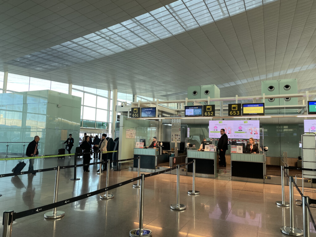 people standing in a line at an airport