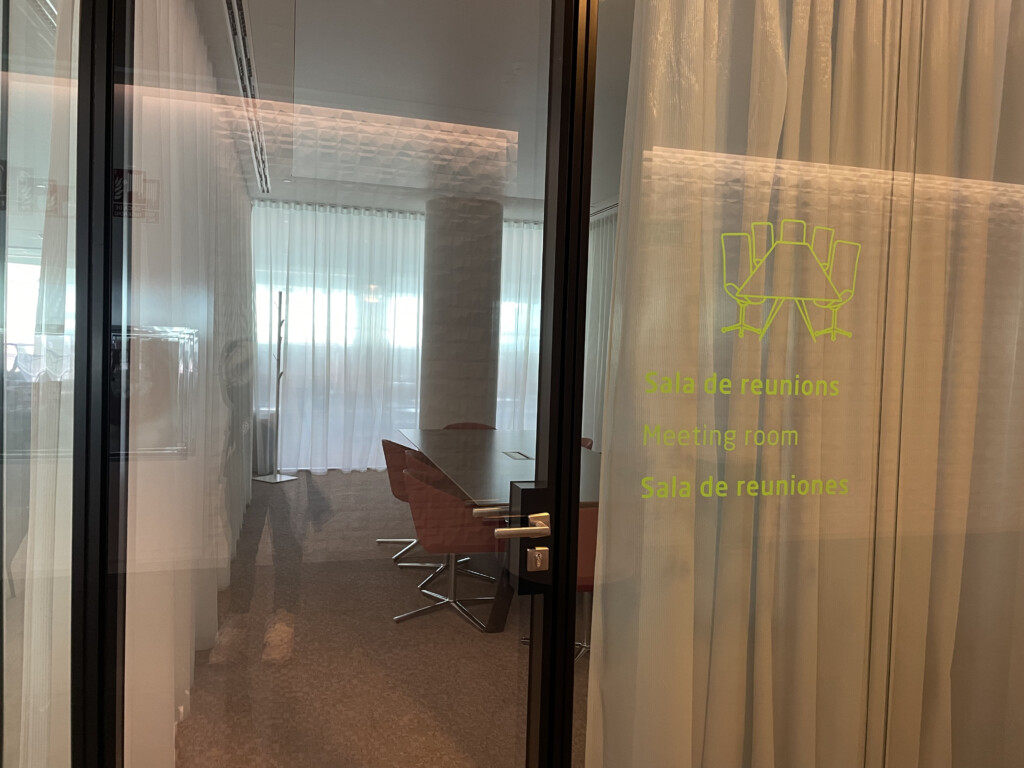 a glass door with a table and chairs in the background