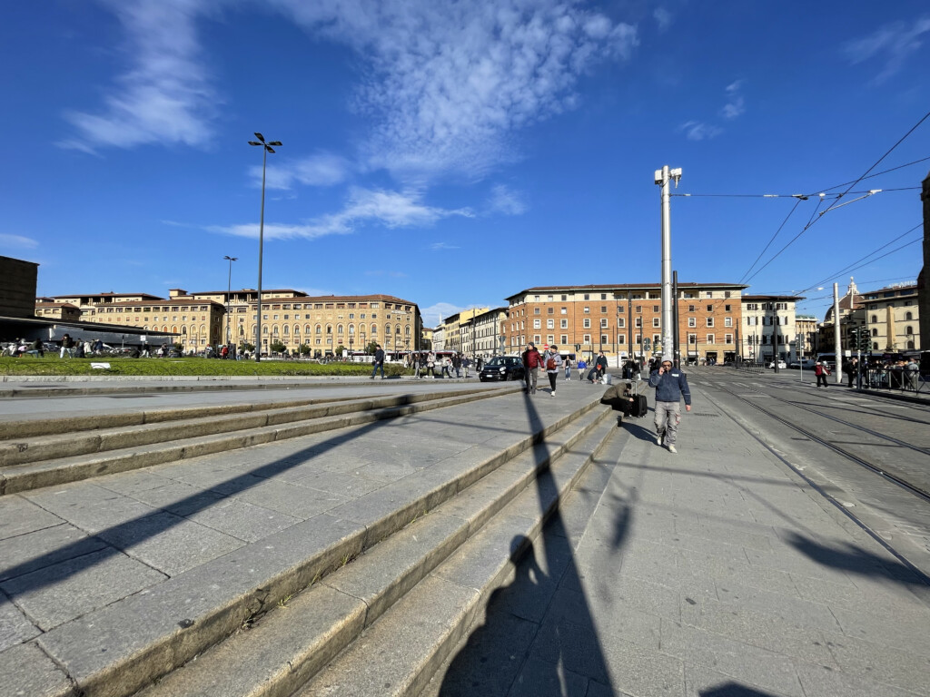 a group of people walking on a sidewalk