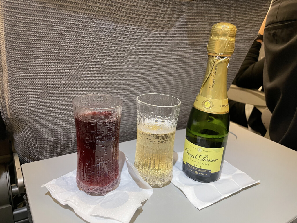 a bottle of champagne and glasses on a table