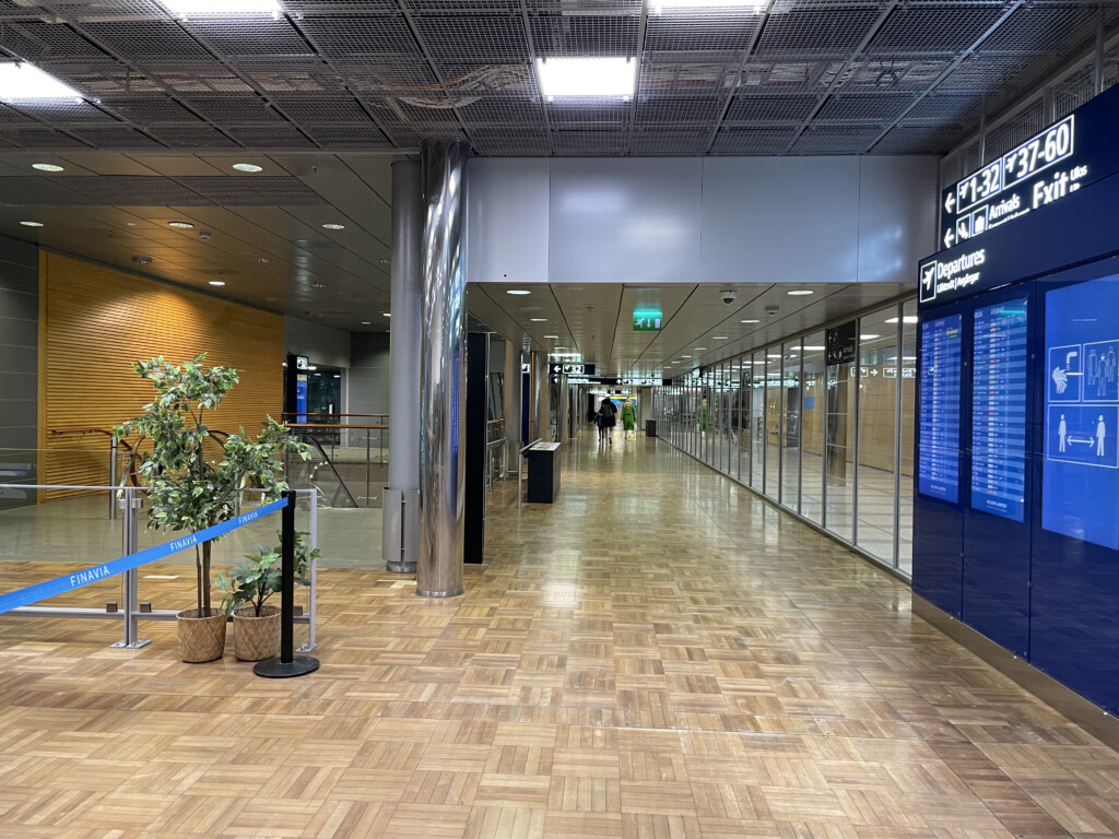 a building with glass walls and a blue sign