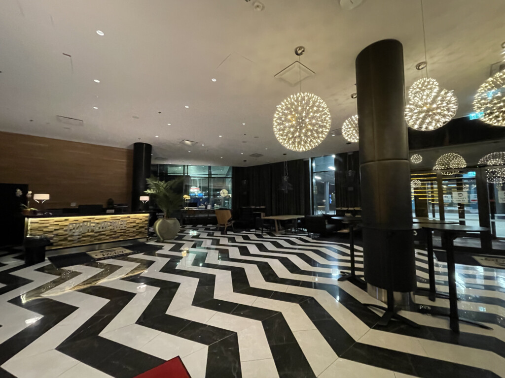 a black and white chevron floor with lights from the ceiling