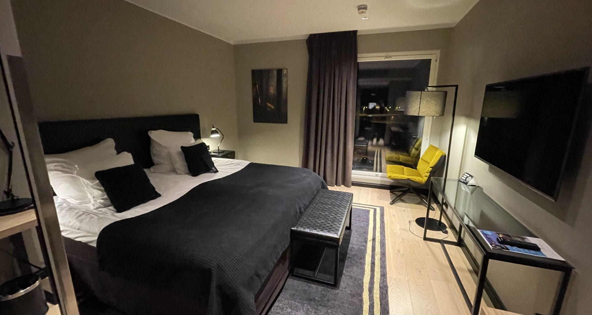 a bedroom with a bed and a television