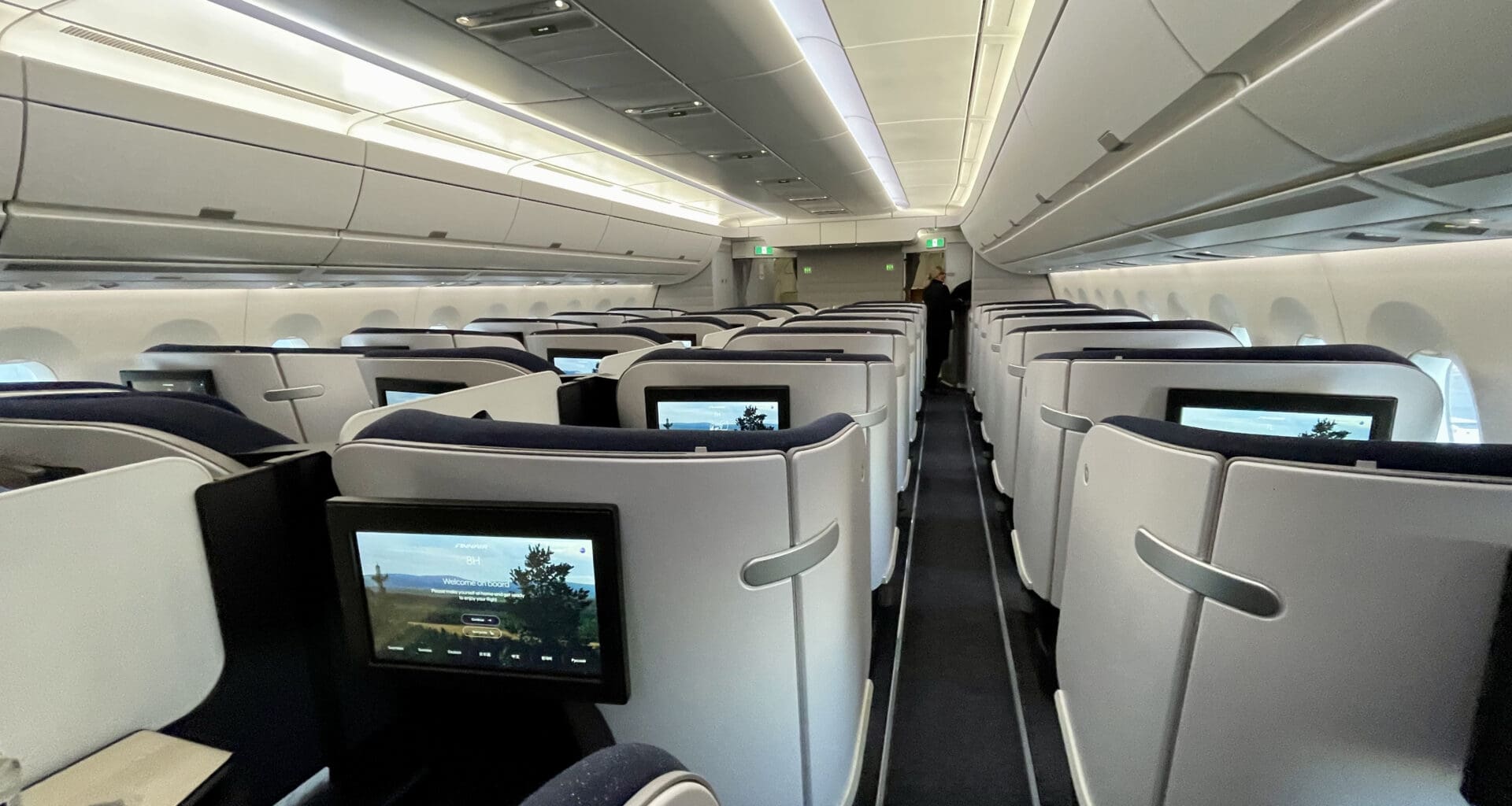 a row of seats with monitors on the side