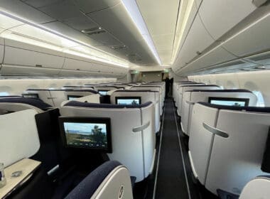 a row of seats with monitors on the side
