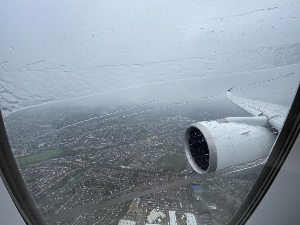 an airplane wing and engine in the sky