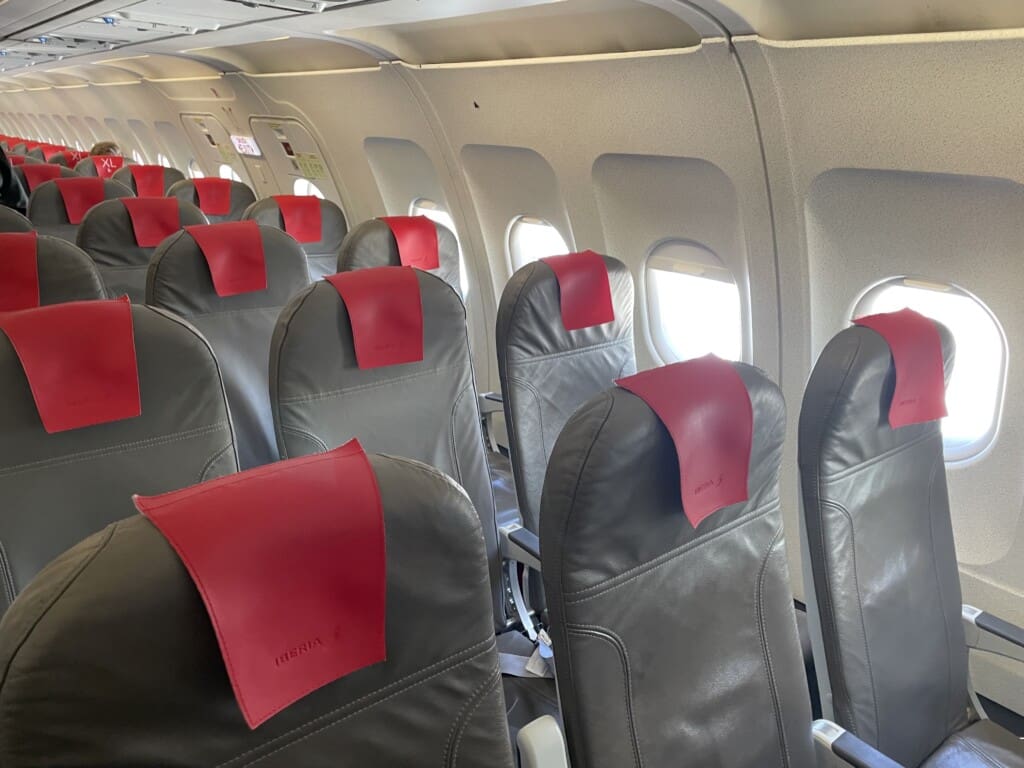 a row of seats with red labels on them