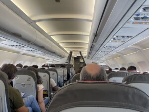 a group of people sitting in an airplane