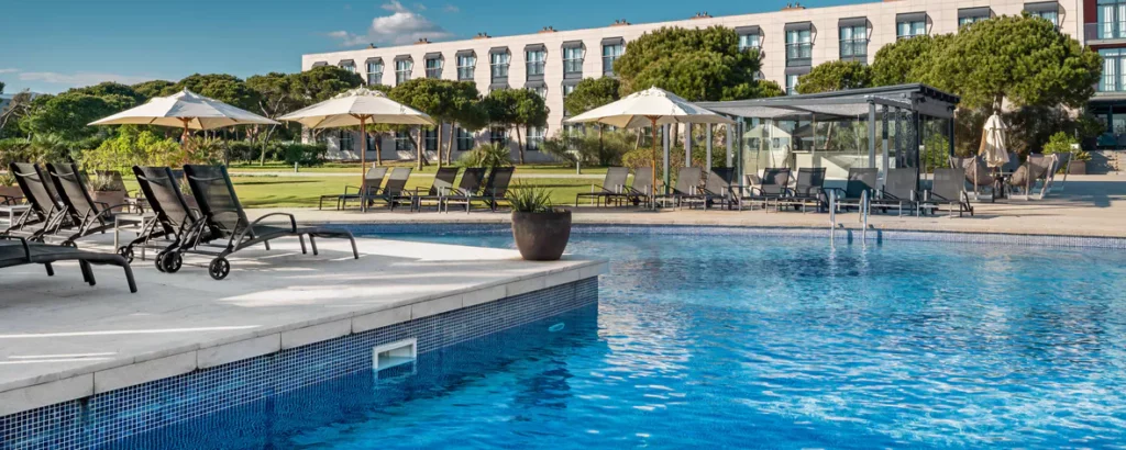 a pool with umbrellas and chairs