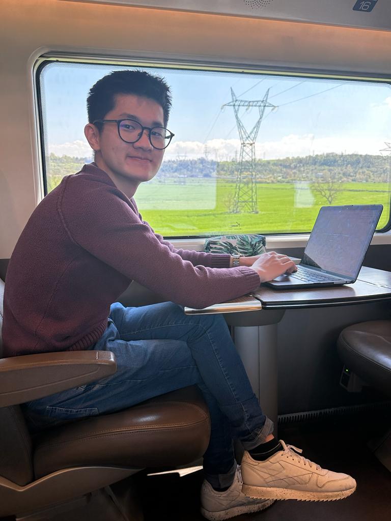 a man sitting at a table with a laptop