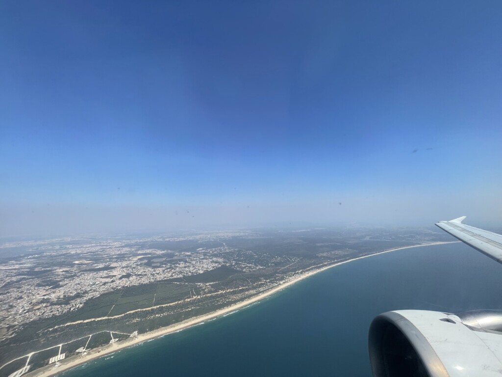 an airplane wing over a body of water