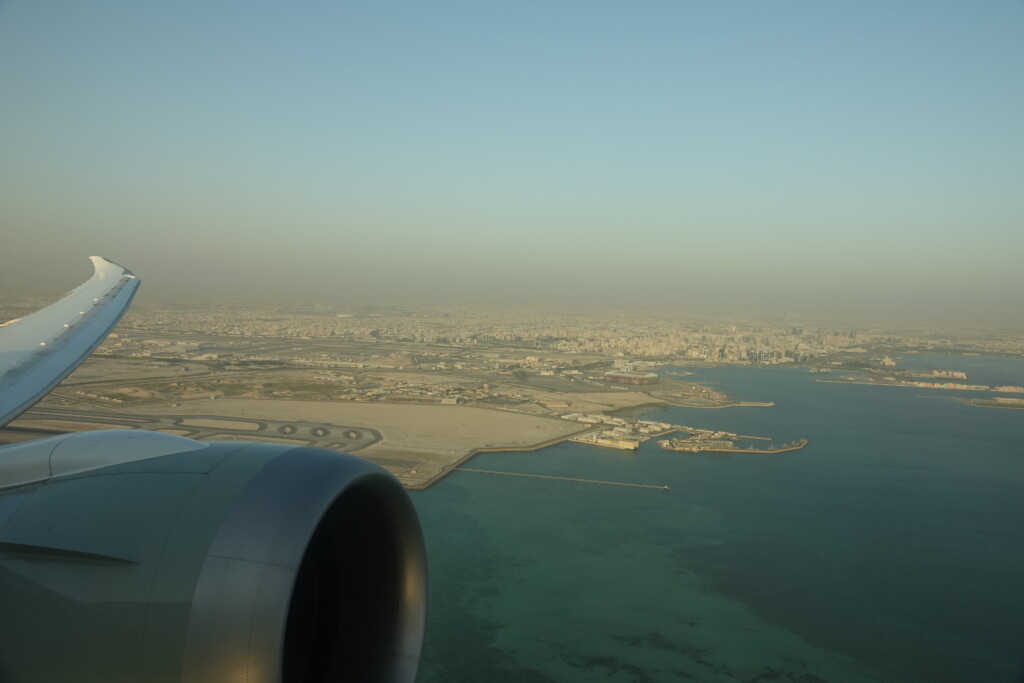 an airplane wing and a body of water