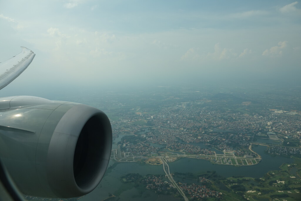 an airplane wing and a city