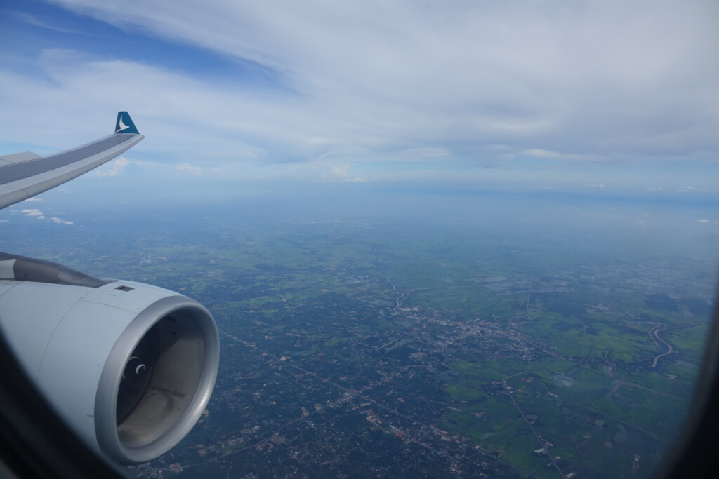 an airplane wing and a view of the earth from the window