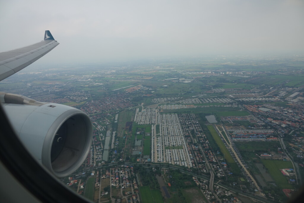 an airplane wing and a city