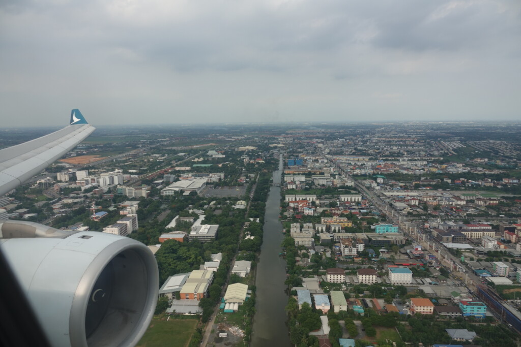 an airplane wing over a city