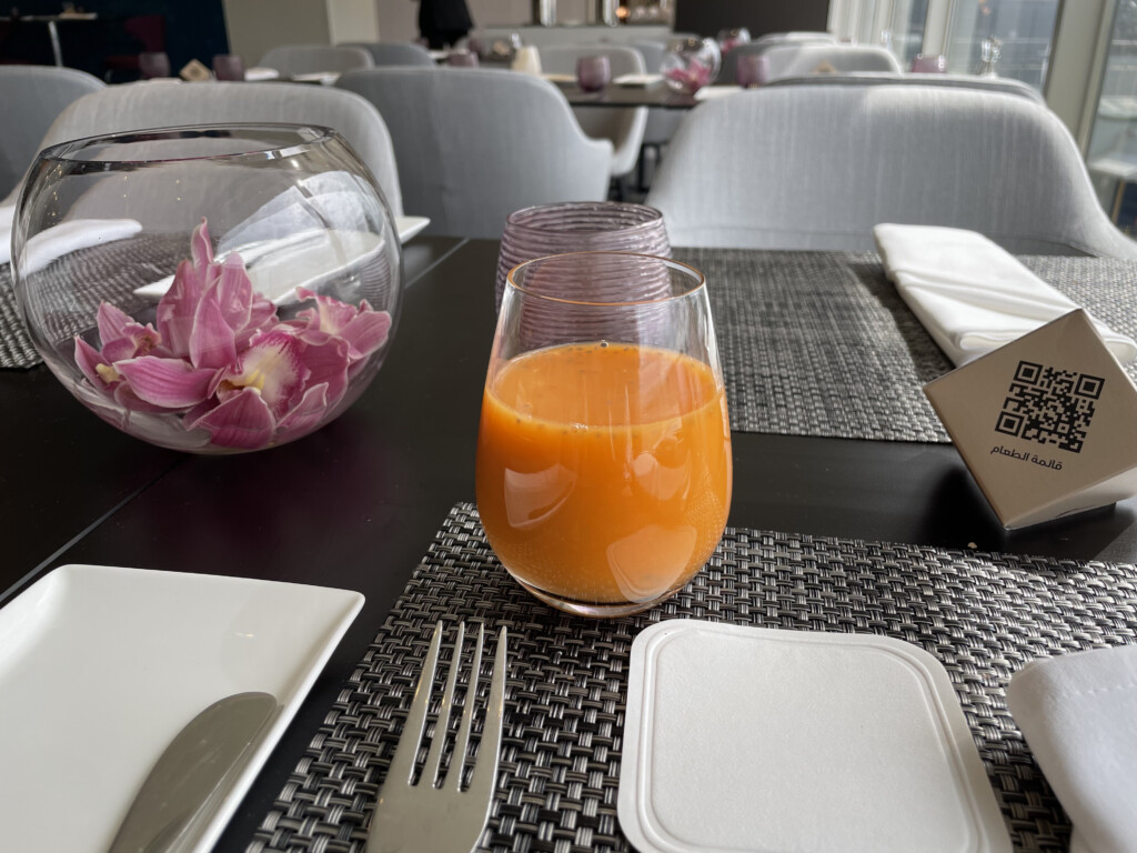 a glass of orange juice on a table