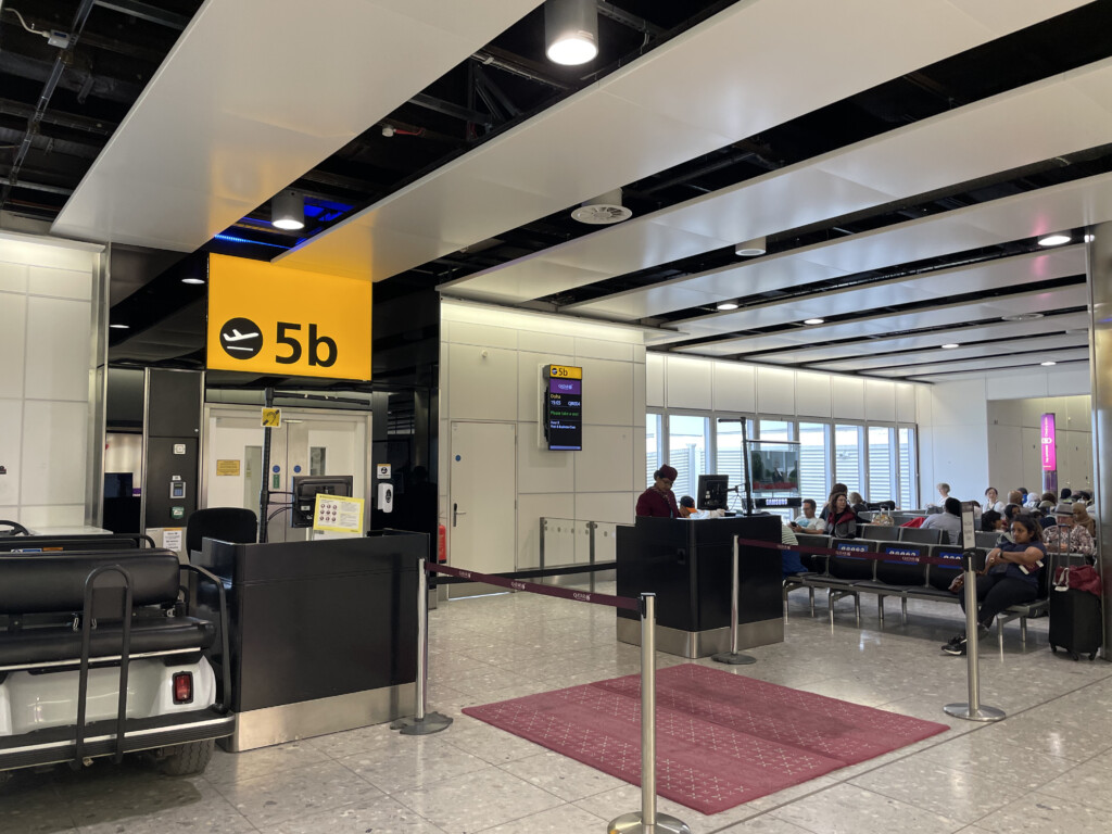 people sitting in a line at an airport