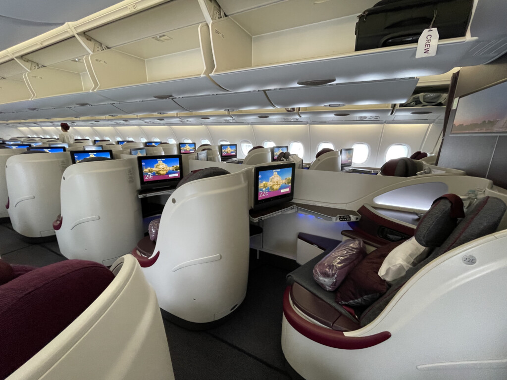 a row of seats with monitors on the side