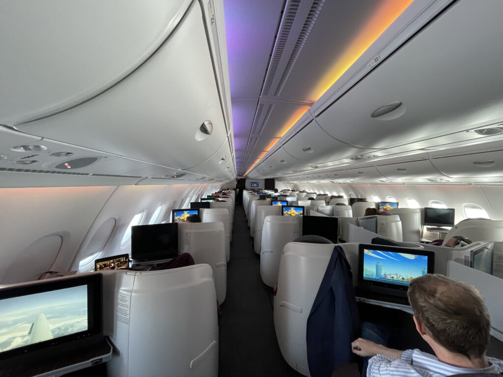 a man sitting in a chair with a computer on the back of a plane