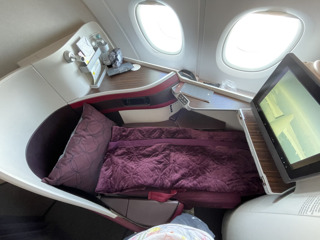 a bed and a tv in an airplane