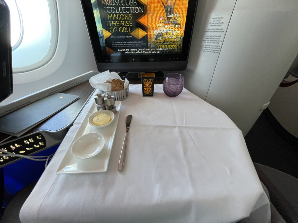 a table with a television and a tray of food