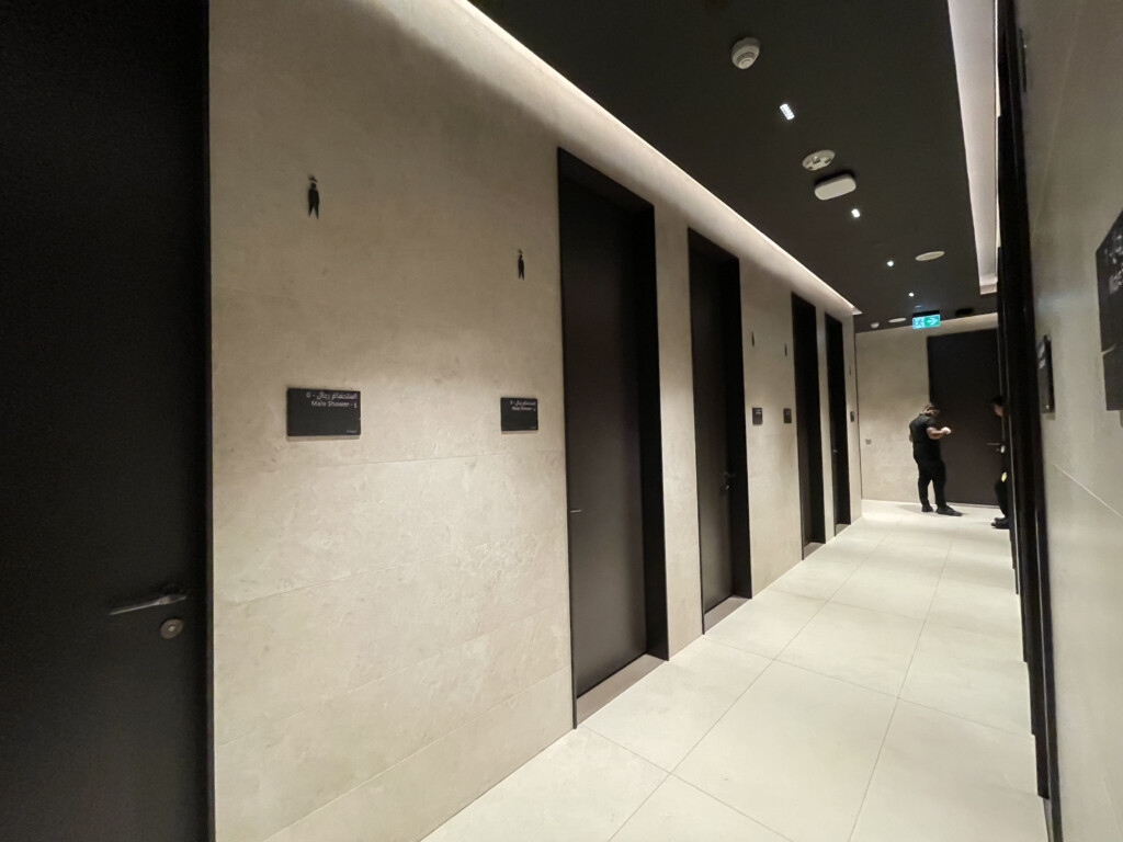 a man standing in a hallway with doors