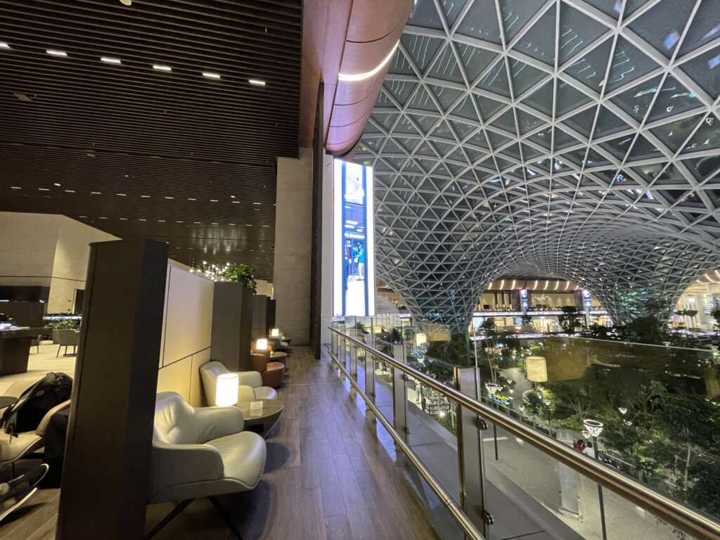 a glass ceiling with a large glass roof and a large sign