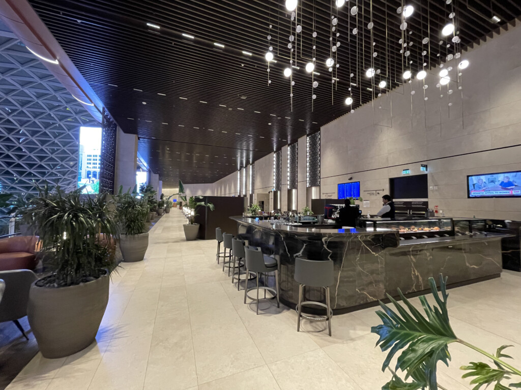 a restaurant with a counter and plants