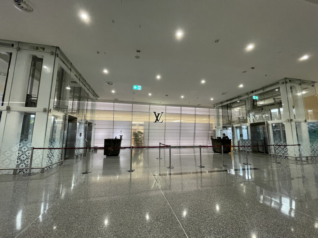 a glass building with a large glass wall and a sign