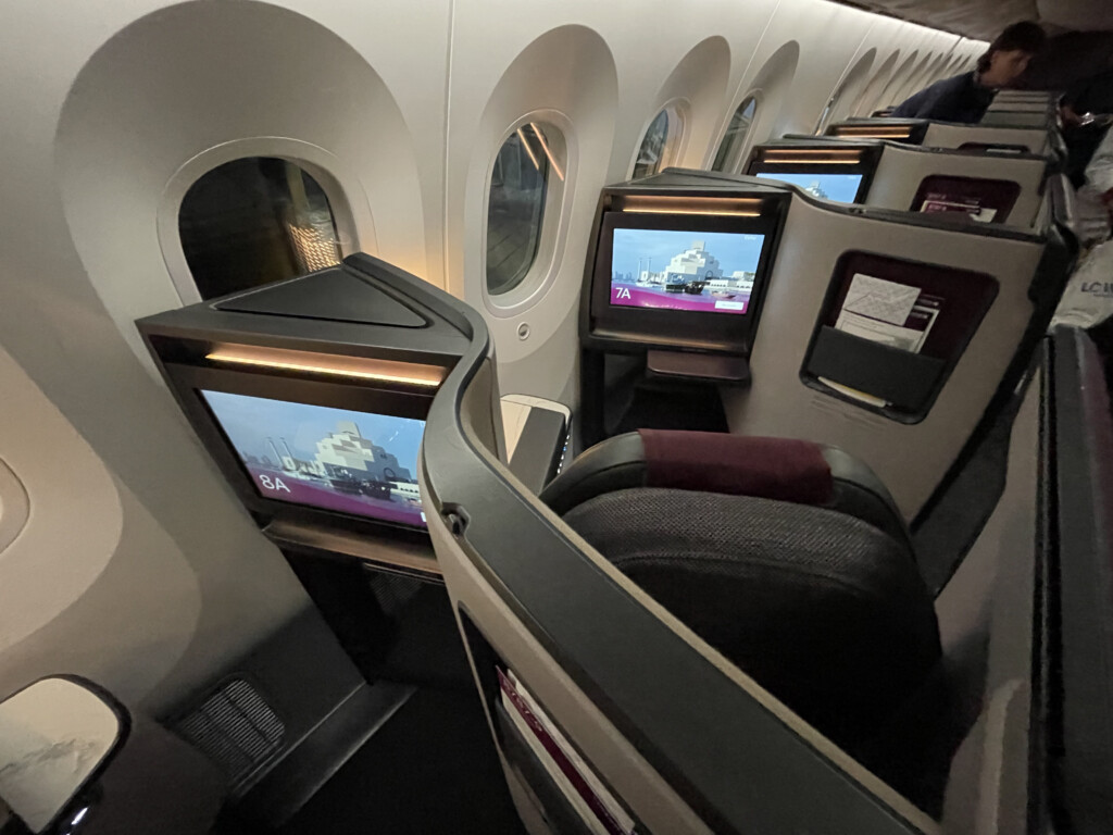 a row of monitors on an airplane