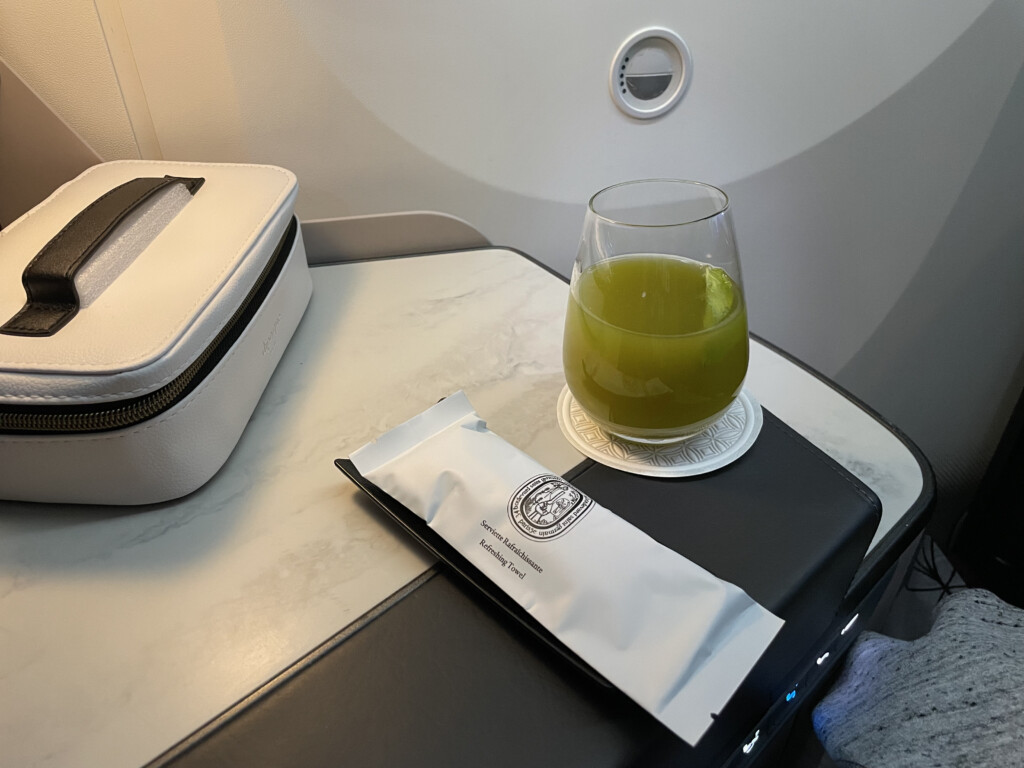 a glass of green liquid on a table