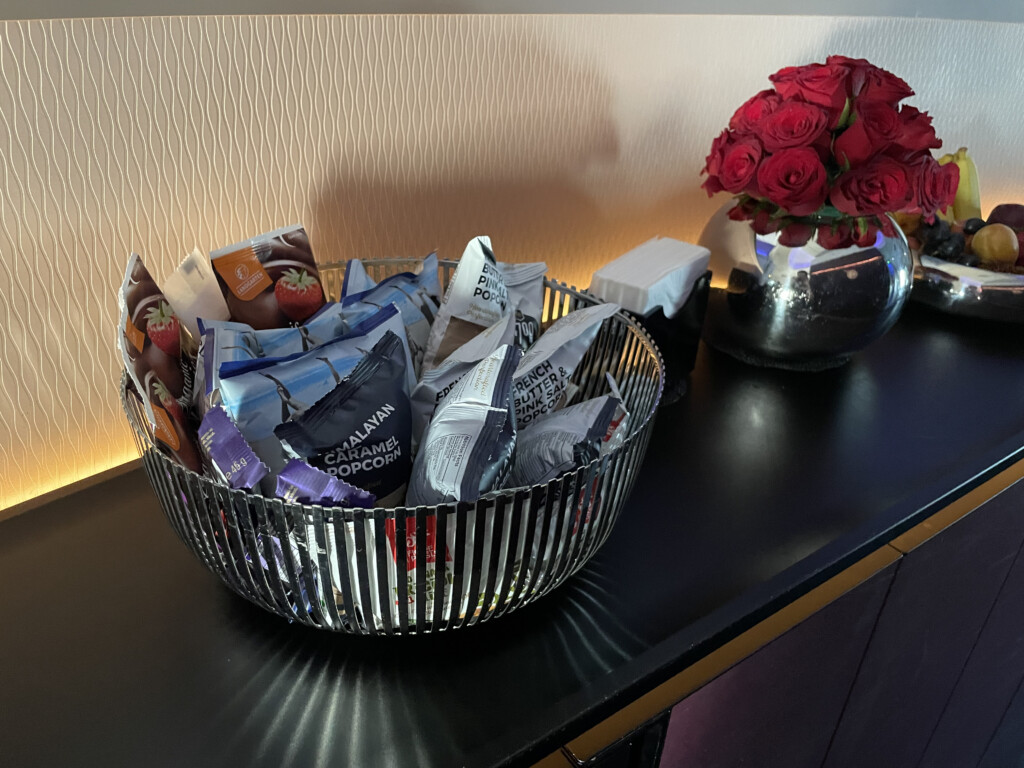 a basket of snacks and a bouquet of roses