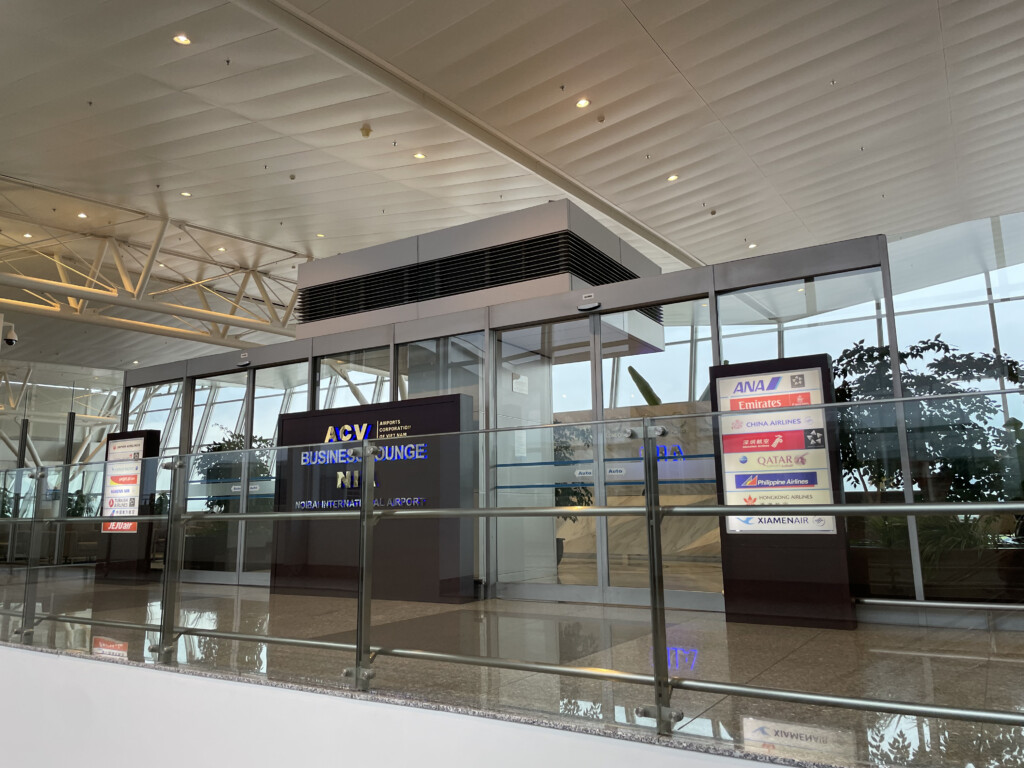 a glass building with a glass wall and a railing