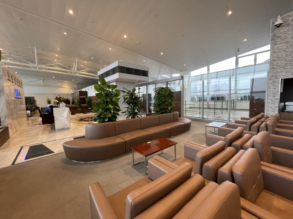 a large room with brown leather couches and tables