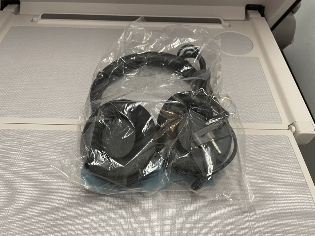 a black headphones in a plastic bag