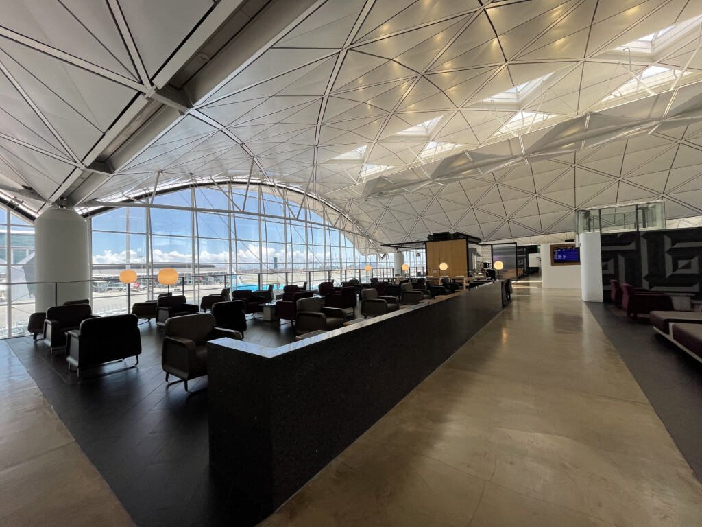 a large glass ceiling with a counter and chairs