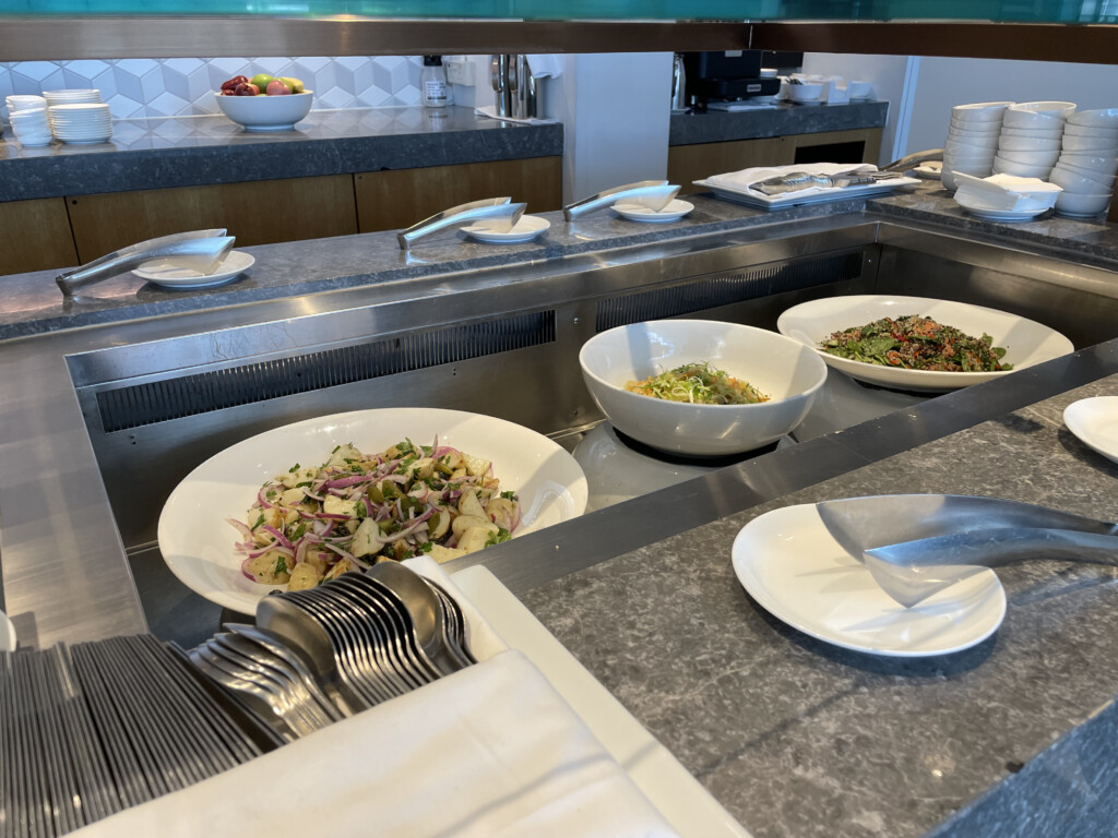 a buffet line with bowls of food