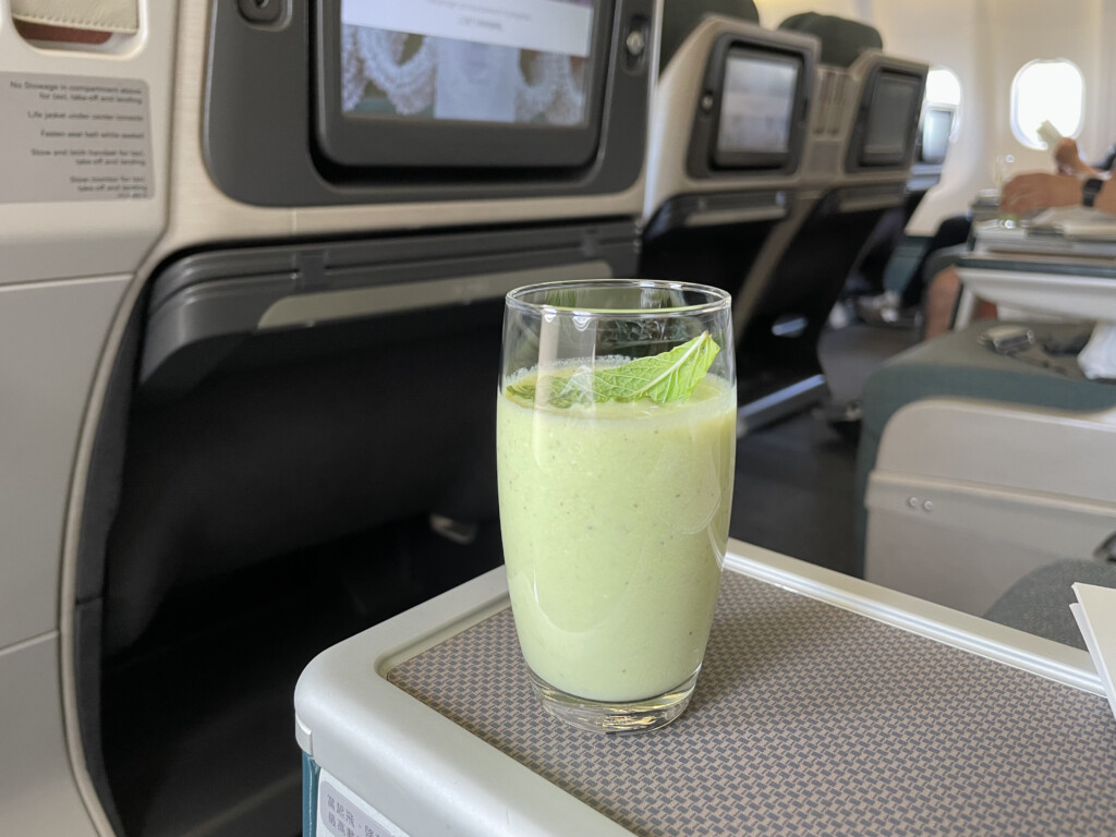 a glass of green smoothie on a table